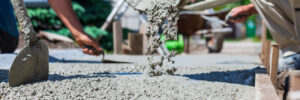 Workers make concrete trips. Trowel, shovel and other devices are used during work.