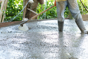 Construction worker is pouring concrete floors, Building construction on site with labor, Home building concept.
