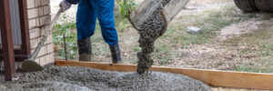 Workers level out the concrete mix at a construction site. Technologies